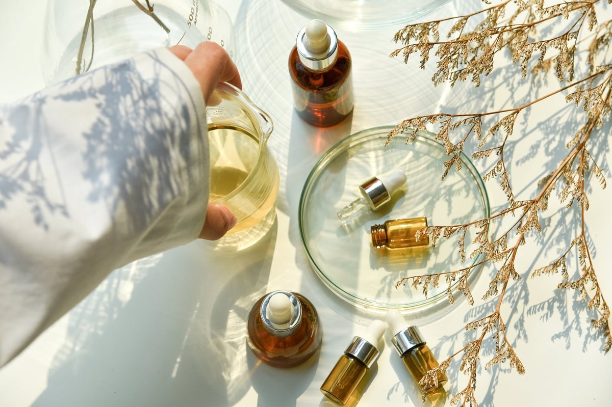 Scientist mixing natural skin care beauty products, Organic oil botany extraction and scientific laboratory glassware